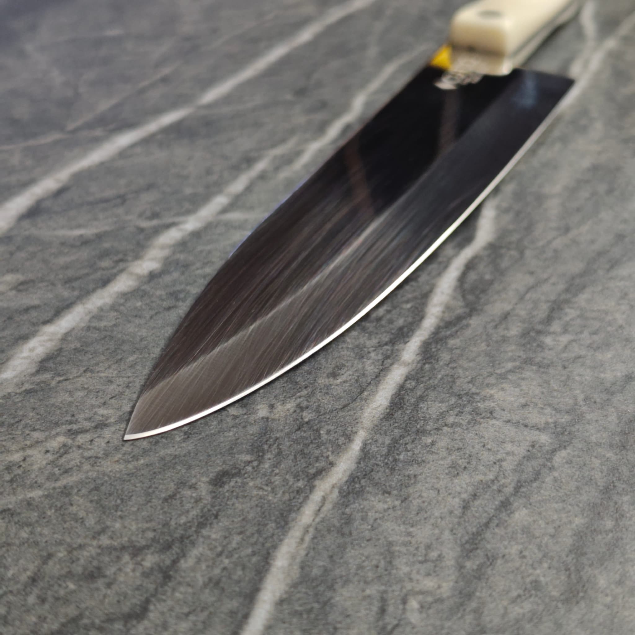 Macro detail of a freshly sharpened knife edge resting on slate