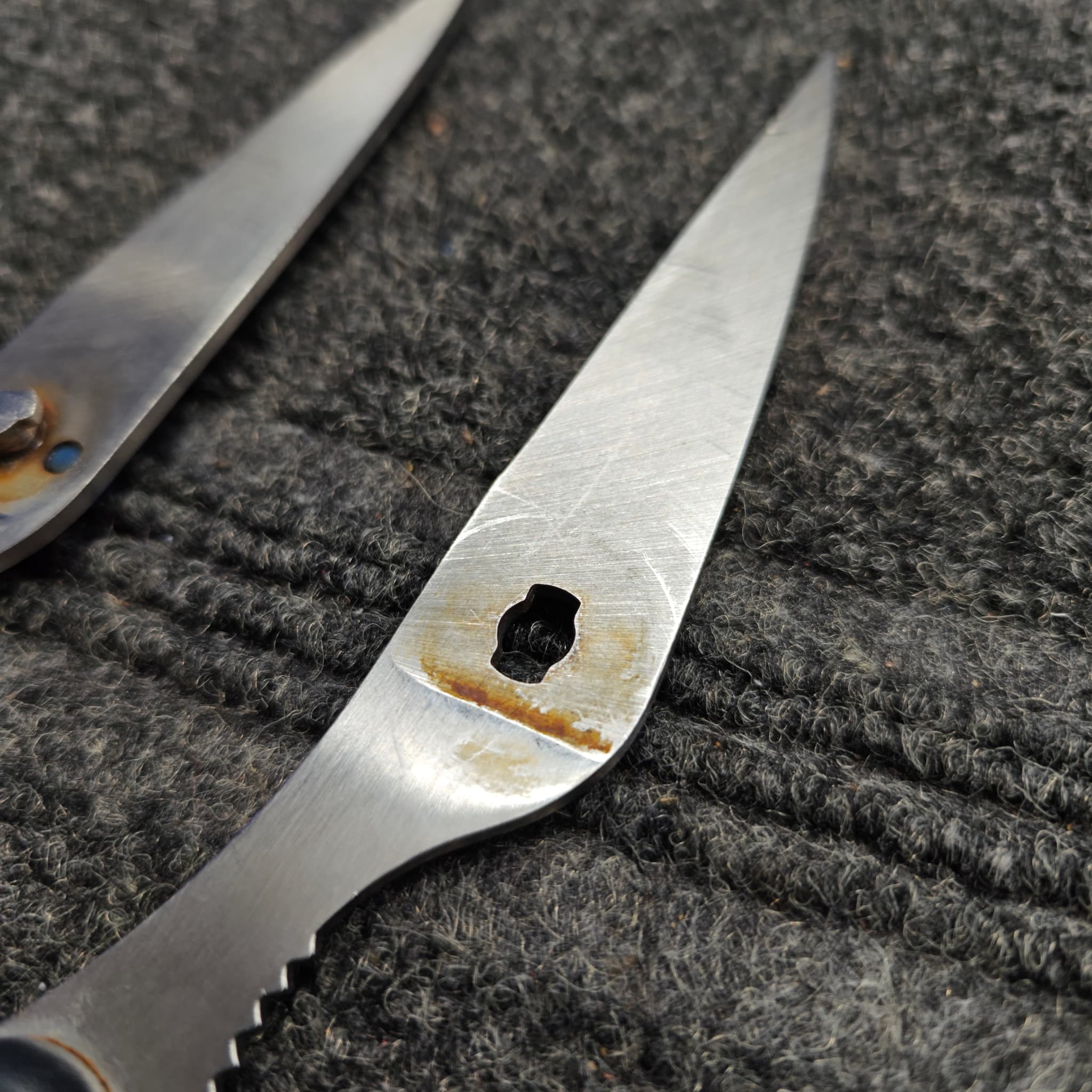 Chef knives lined up for sharpening