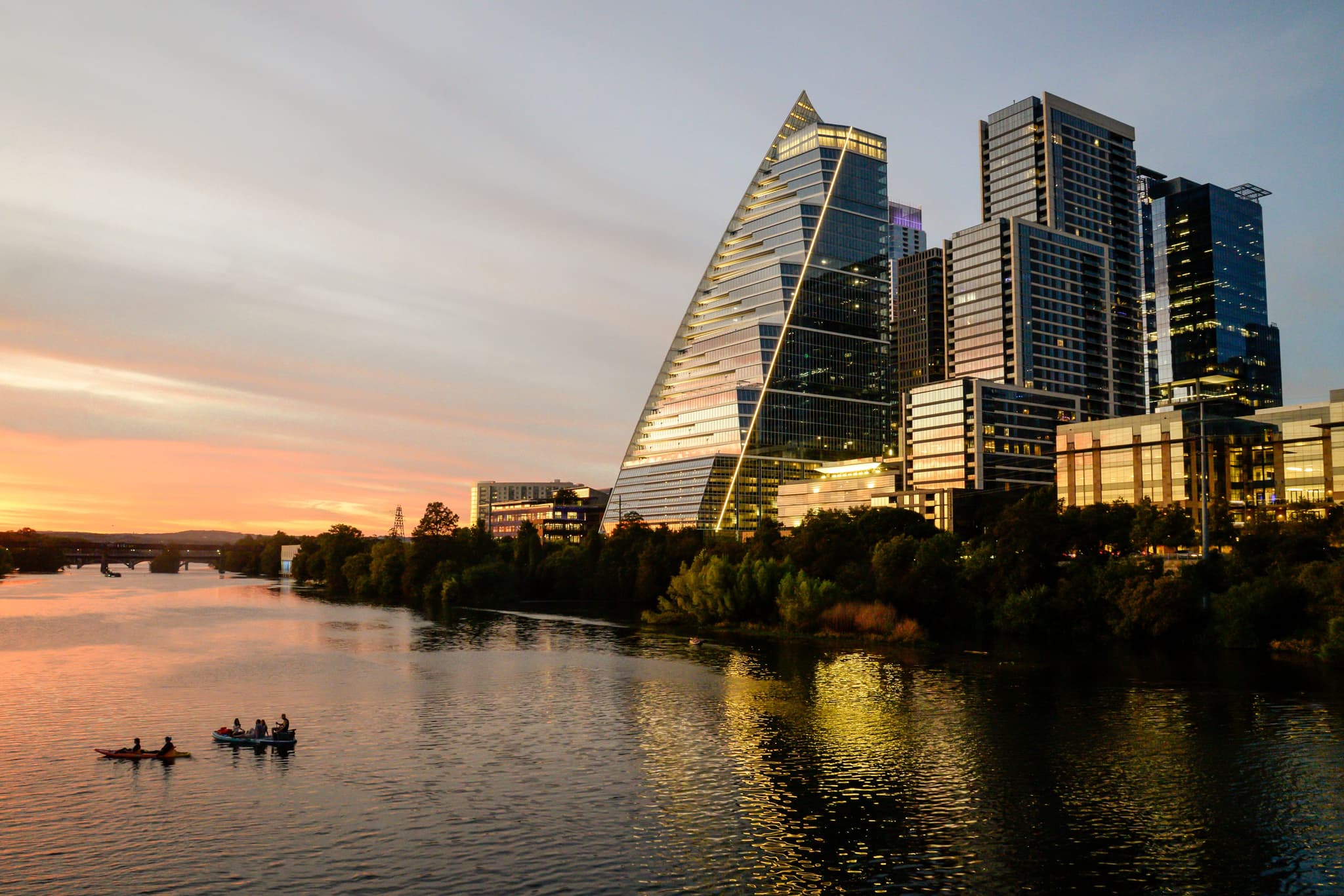 Austin, TX skyline at dusk from Lady Bird Lake with kayakers on the water